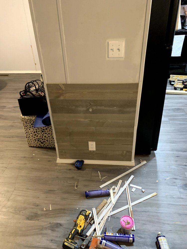 A bunch of tools are laying on the floor in a room.