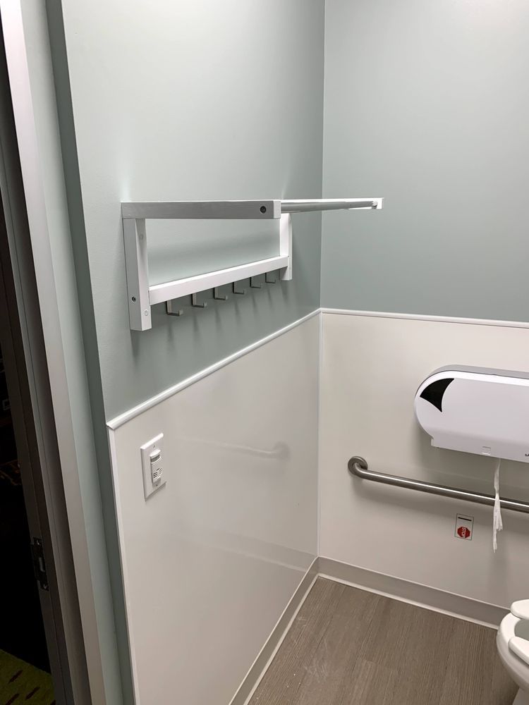 A bathroom with a toilet and a changing table.