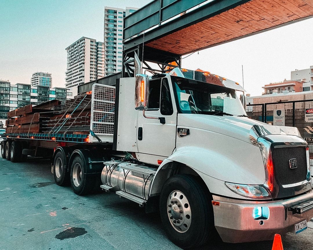 White Semi-Truck Hauling Lumber in An Urban Setting — Highlands Water Cartage in South West Sydney, NSW