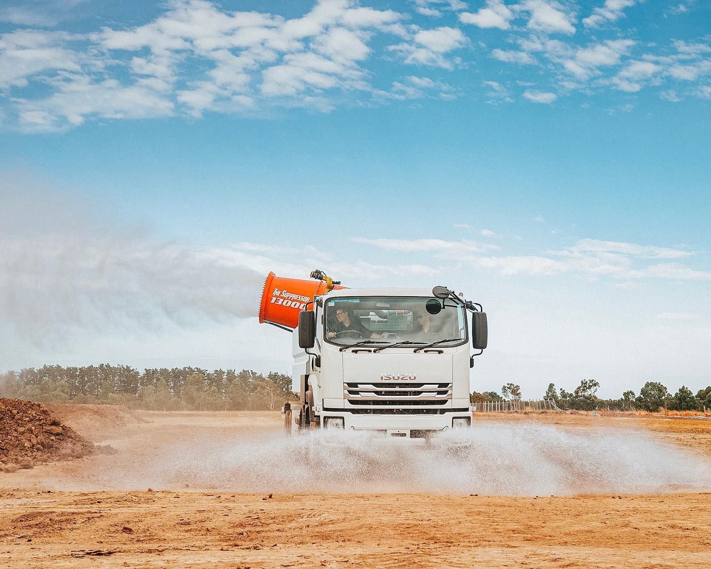 Truck Spraying Water on Dry, Brown Field Under a Blue Sky — Highlands Water Cartage in South West Sydney, NSW