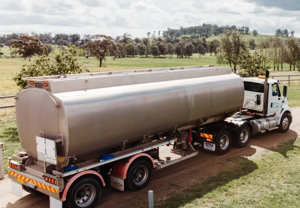 Tanker truck on a driveway, with a grassy field and trees in the background — Highlands Water Cartage in Glenquarry, NSW
