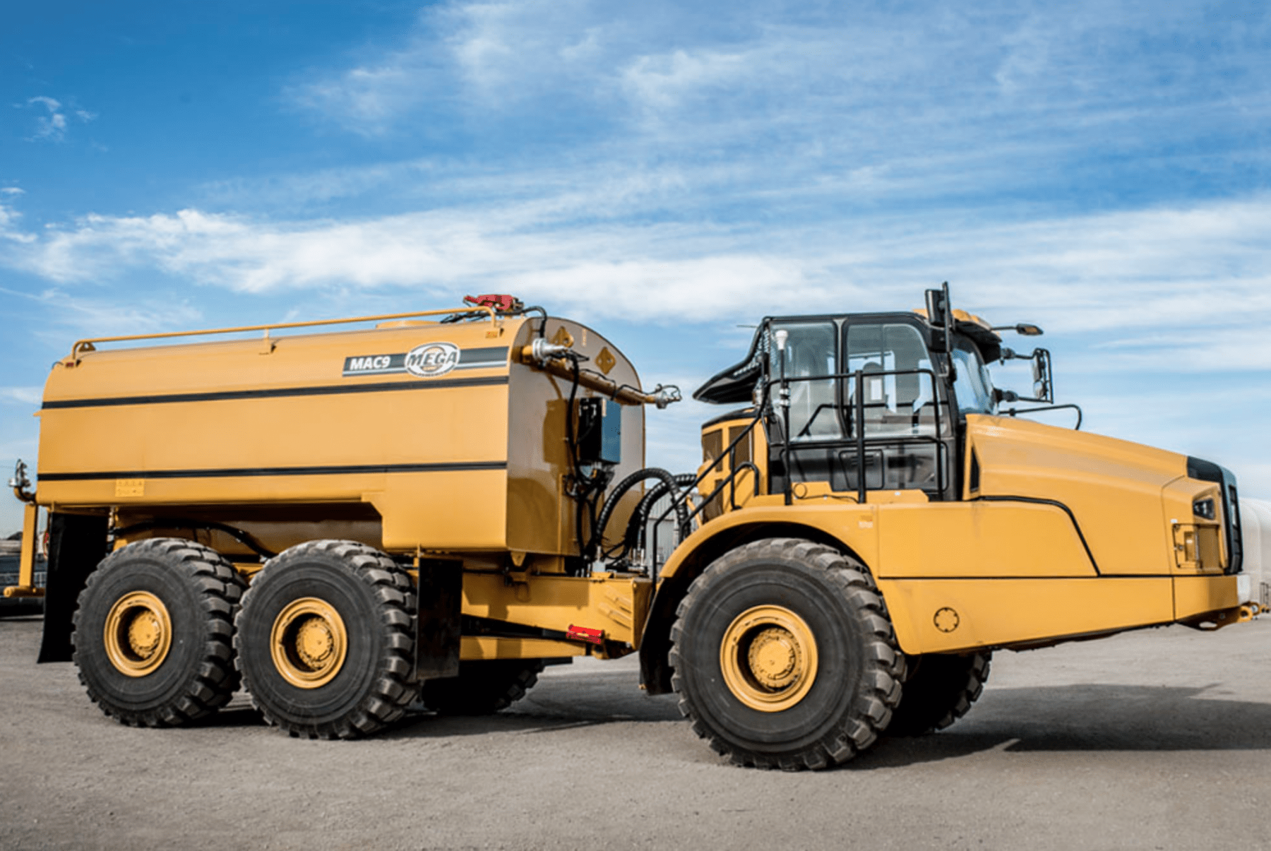 Yellow water truck on wheels, outdoors under a blue sky — Highlands Water Cartage in Glenquarry, NSW