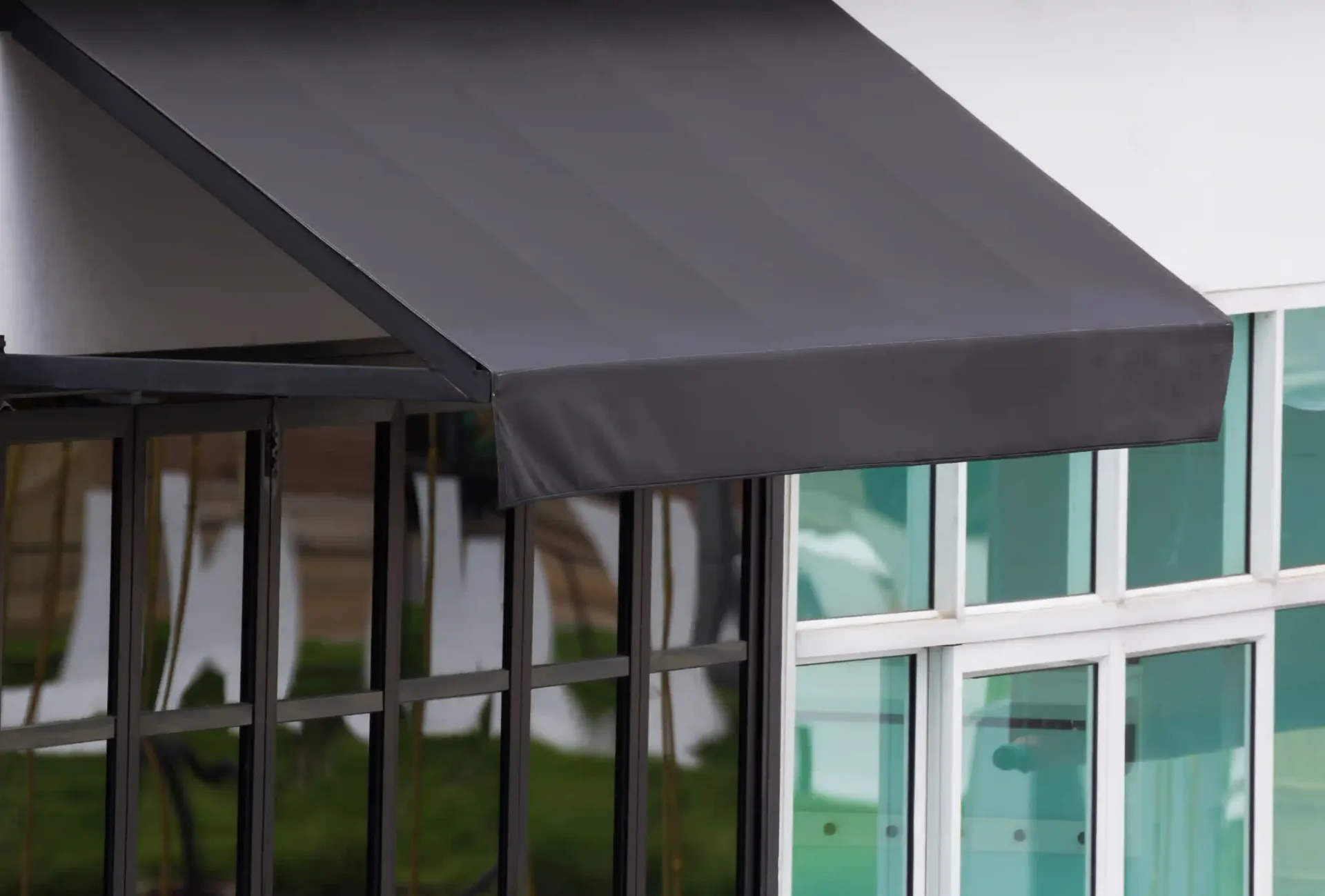 A close-up of a modern black canvas awning provided by a specialized canvas awning supplier.
