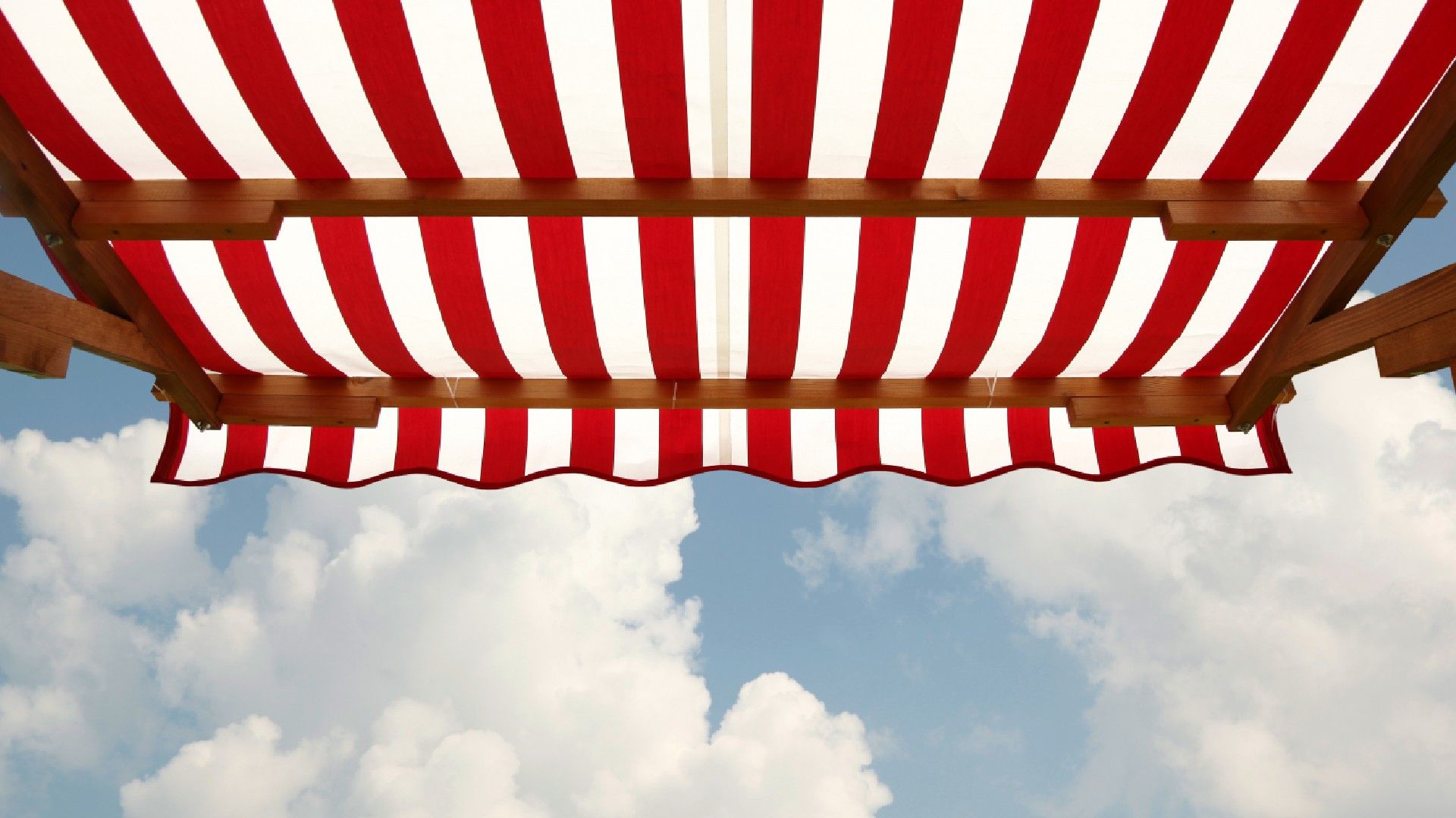 Red and white striped fabric awning providing outdoor shade