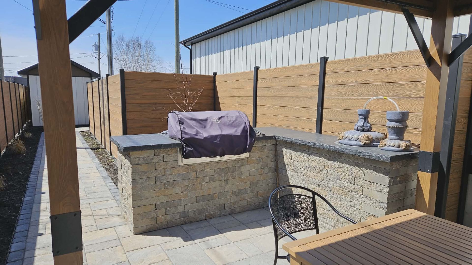 Scène au bord du lac avec des arbres, une terrasse et le reflet du soleil sur l'eau.