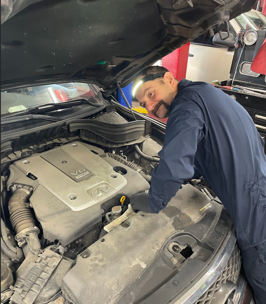 Mid-century modern credenza with a lamp and decorative objects, in a sunlit room.