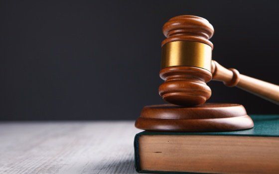 wooden judge gavel and law books