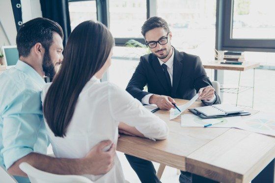 young man and woman talking with lawyer