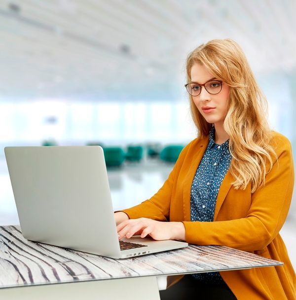 Girl Wearing Prescription Glasses & Typing on Laptop - Optometrist Expert Care in Coconut Grove, NT