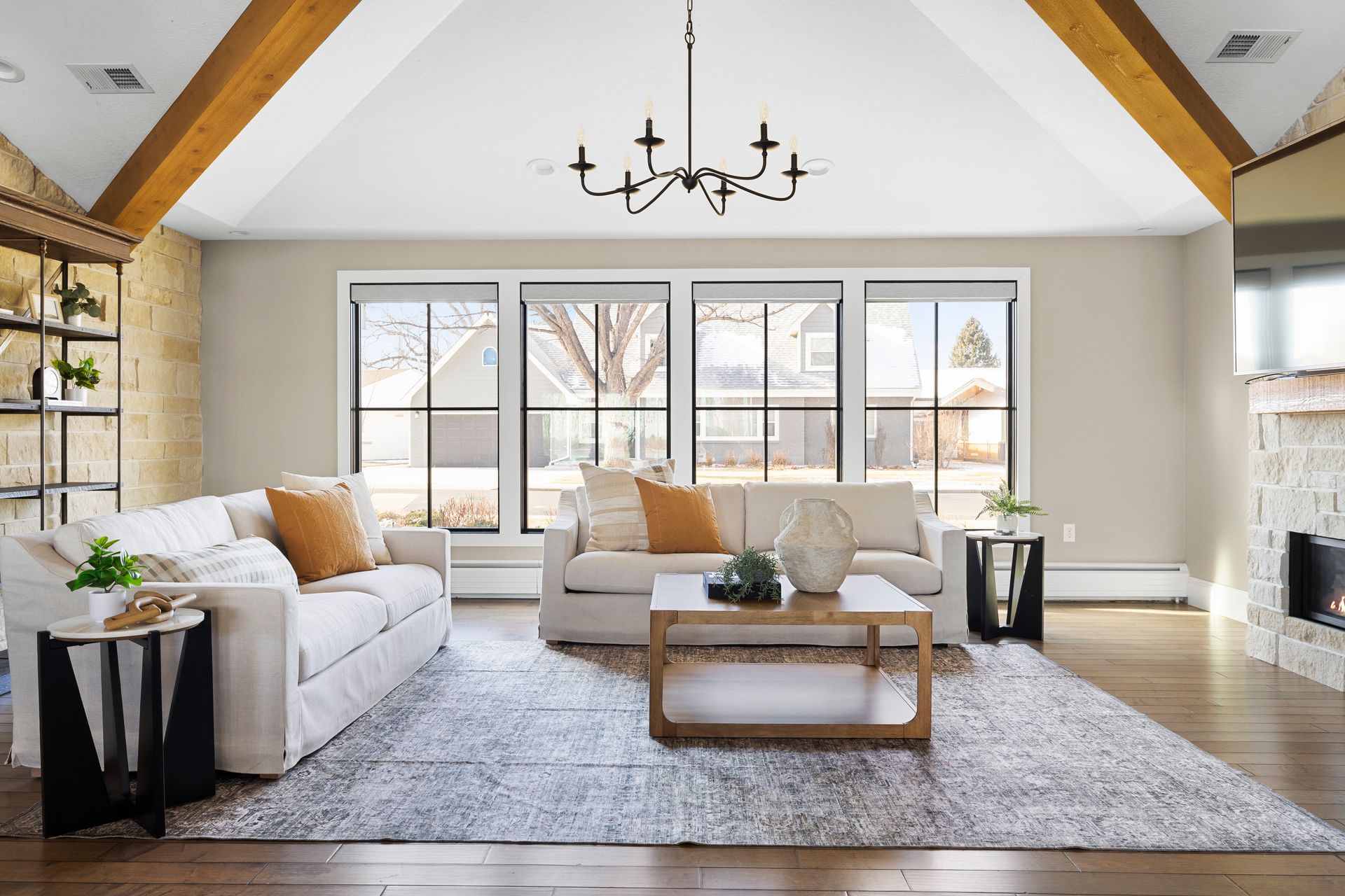 Living room with neutral tones, couches, and a large window.