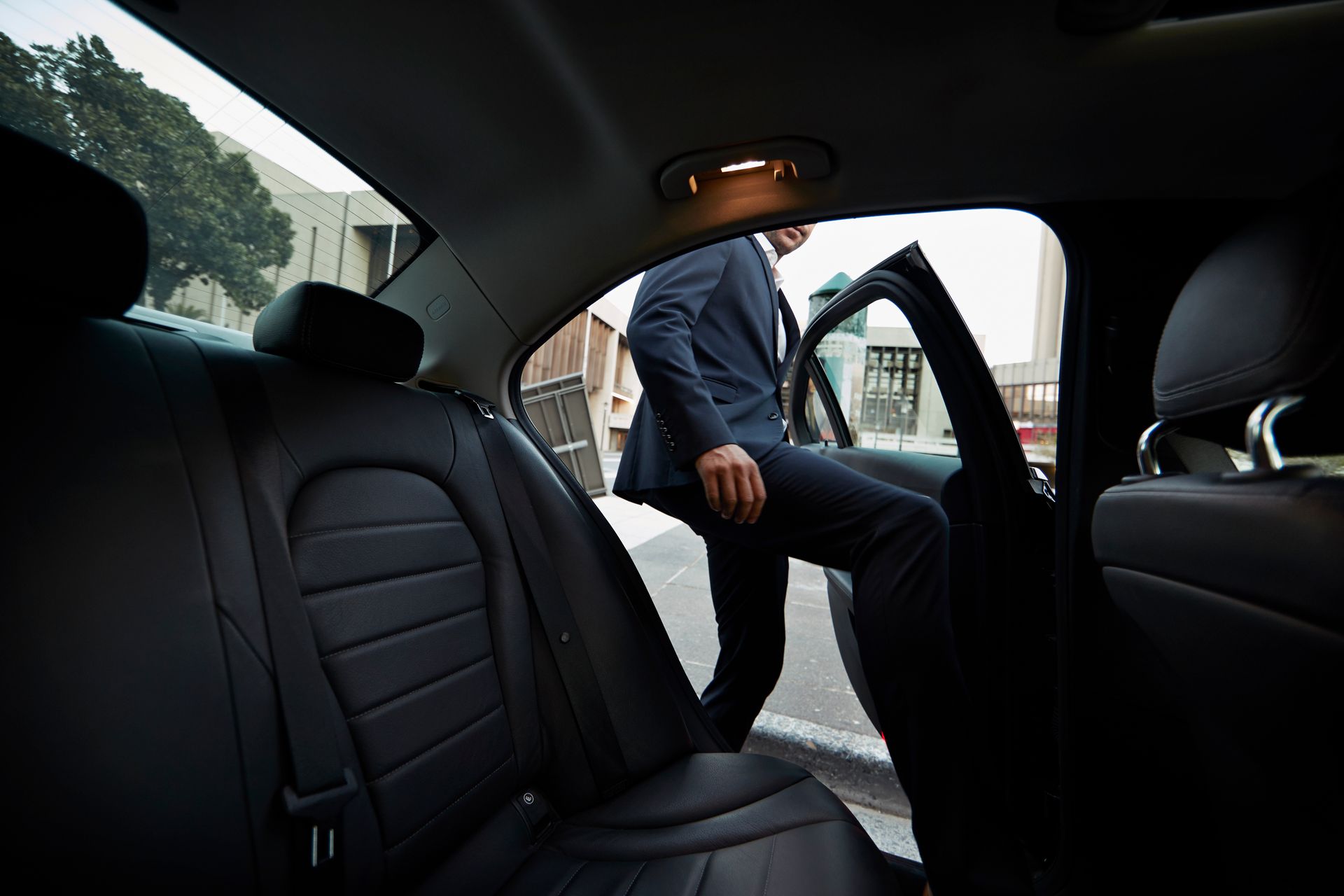 Businessman entering A Hudson Valley Limousine exclusive vehicle for airport transportation services in Poughkeepsie, NY