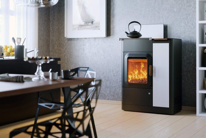 Cucina moderna con stufa a legna bianca e nera e teiera sopra.