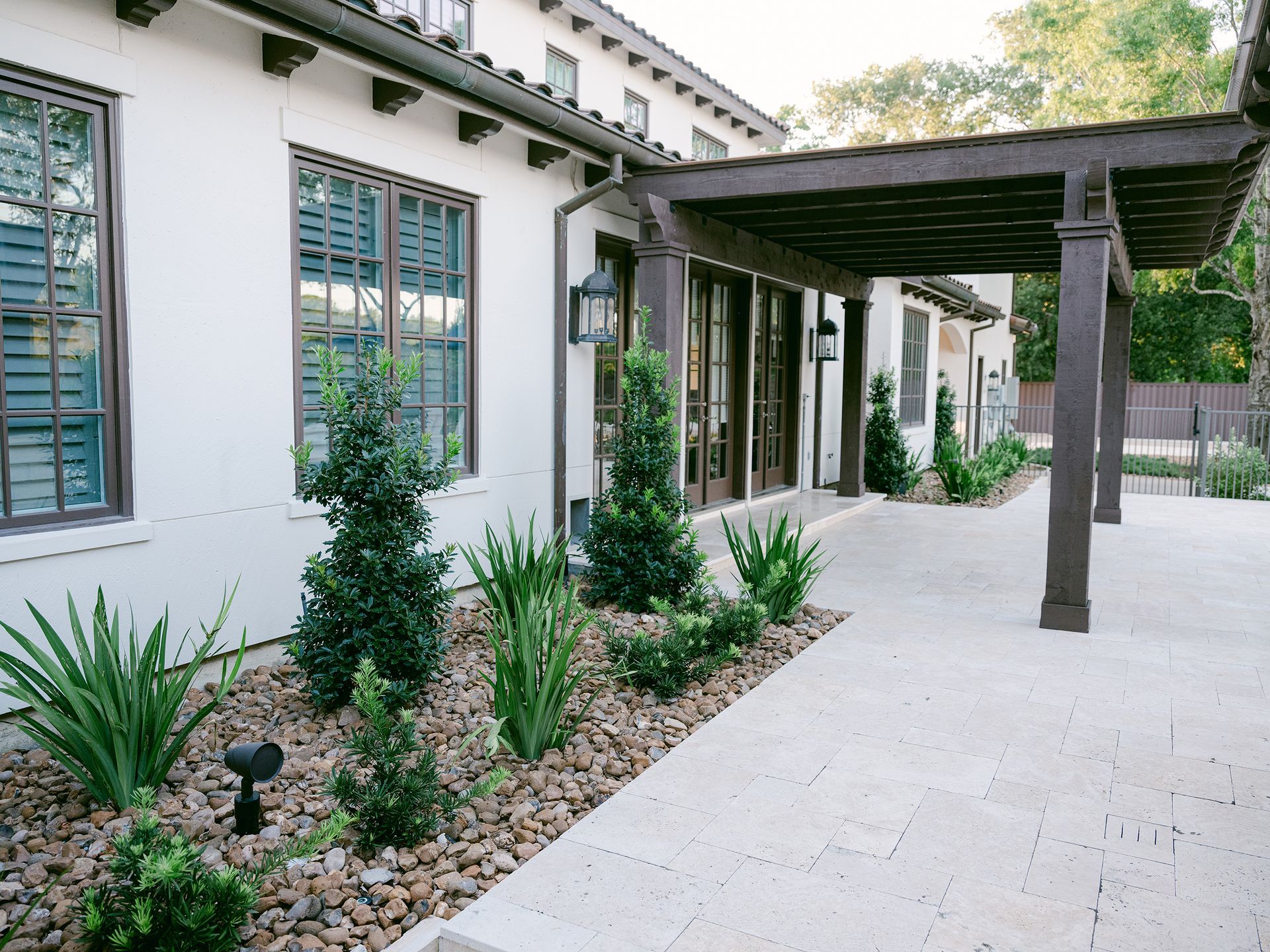 A white house with a covered walkway leading to it