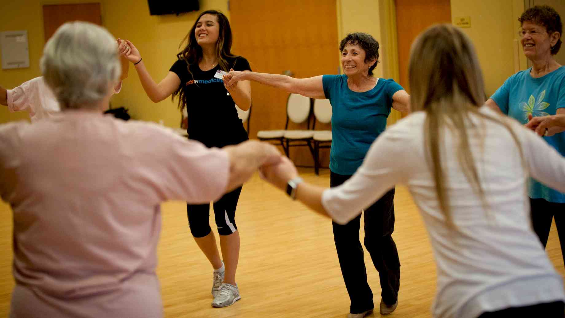 group of people dancing from center of arts in medicine