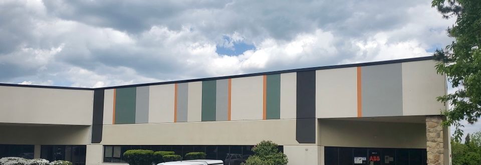 A large building with a cloudy sky in the background.