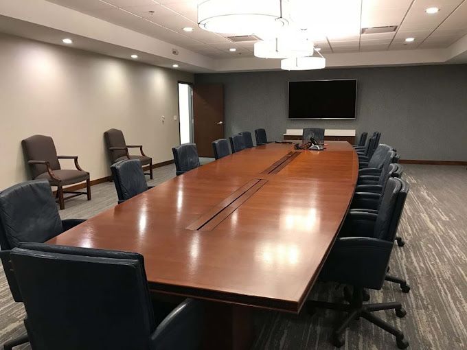 A conference room with a long table and chairs