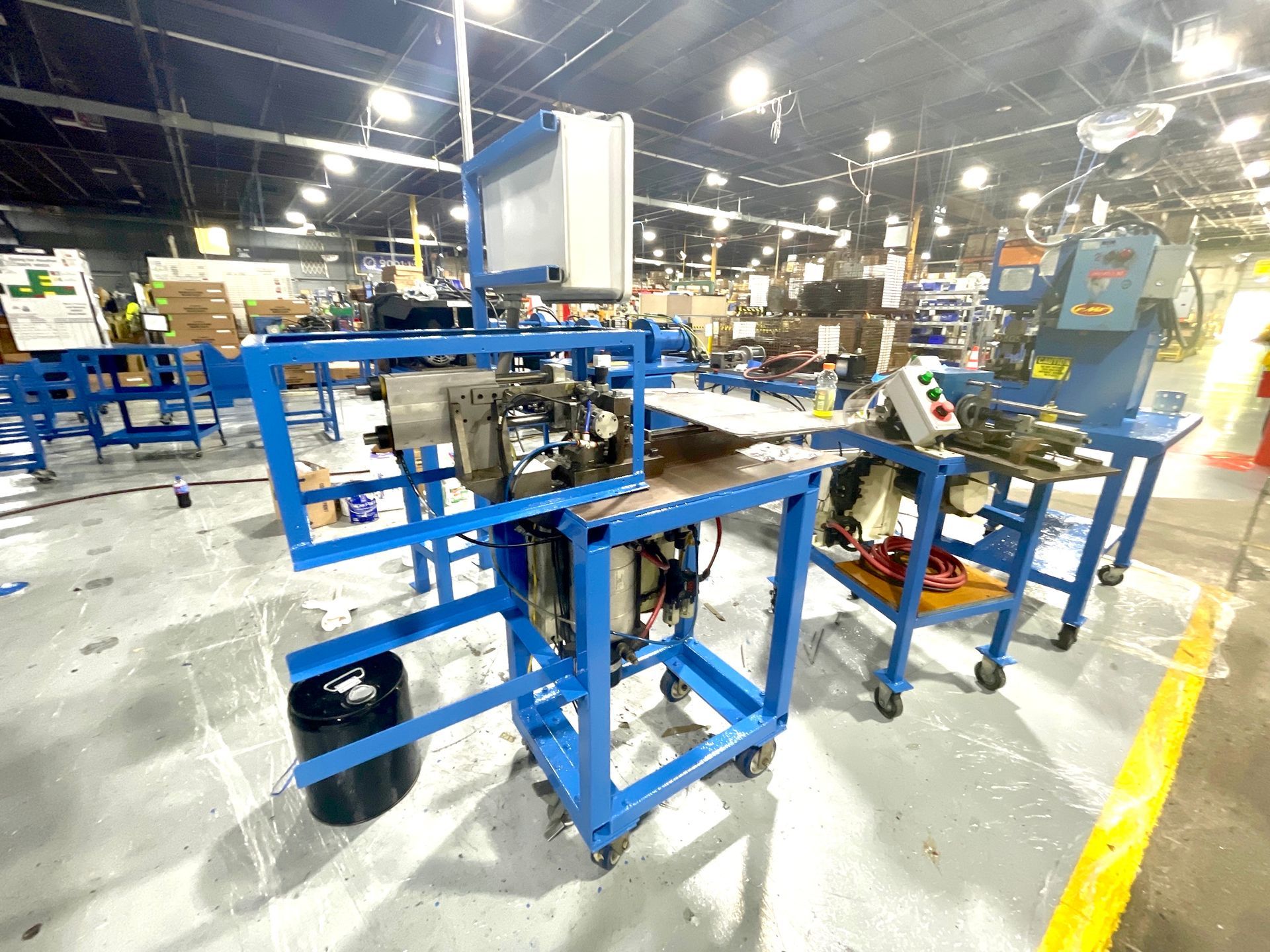 A factory filled with lots of blue tables and machinery.