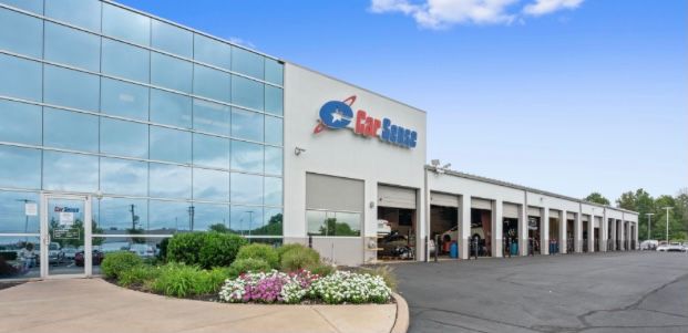 A large building with a lot of windows and flowers in front of it.