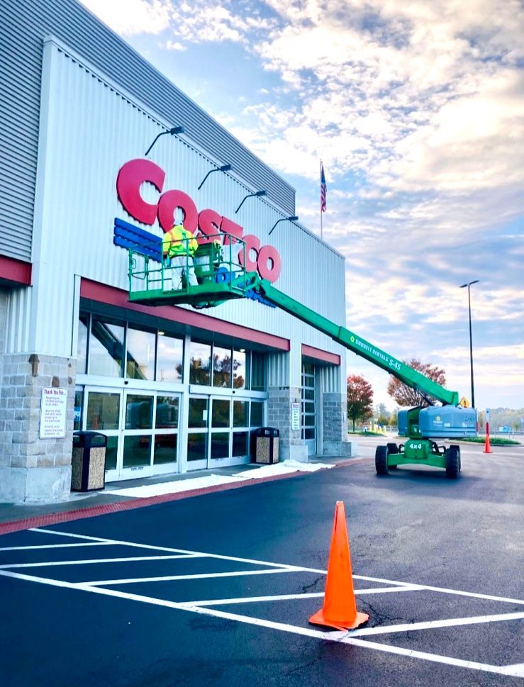 A costco store is being painted in red and blue