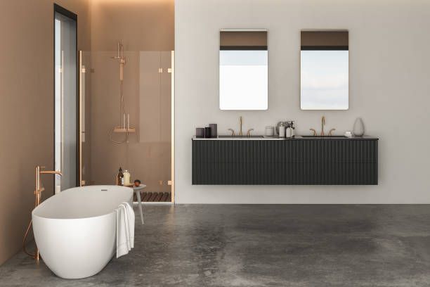 Modern bathroom design featuring polished concrete floors with freestanding bathtub