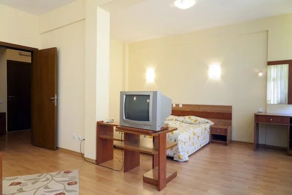Medical office reception desk with visitor check-in area and room number display.