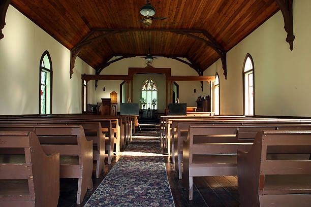 Historic chapel interior with wooden pews and vaulted ceiling.