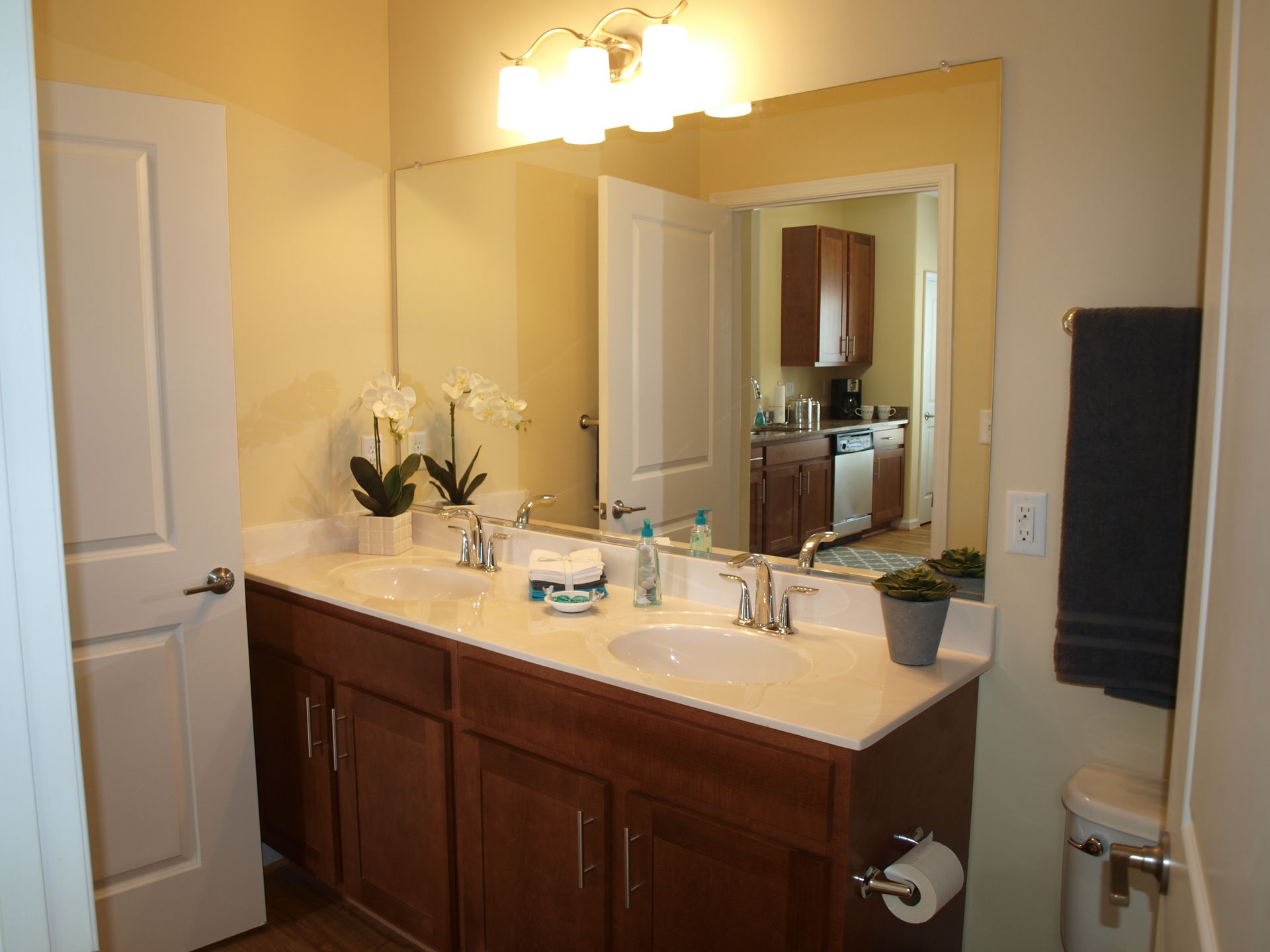 A bathroom with two sinks and a large mirror.