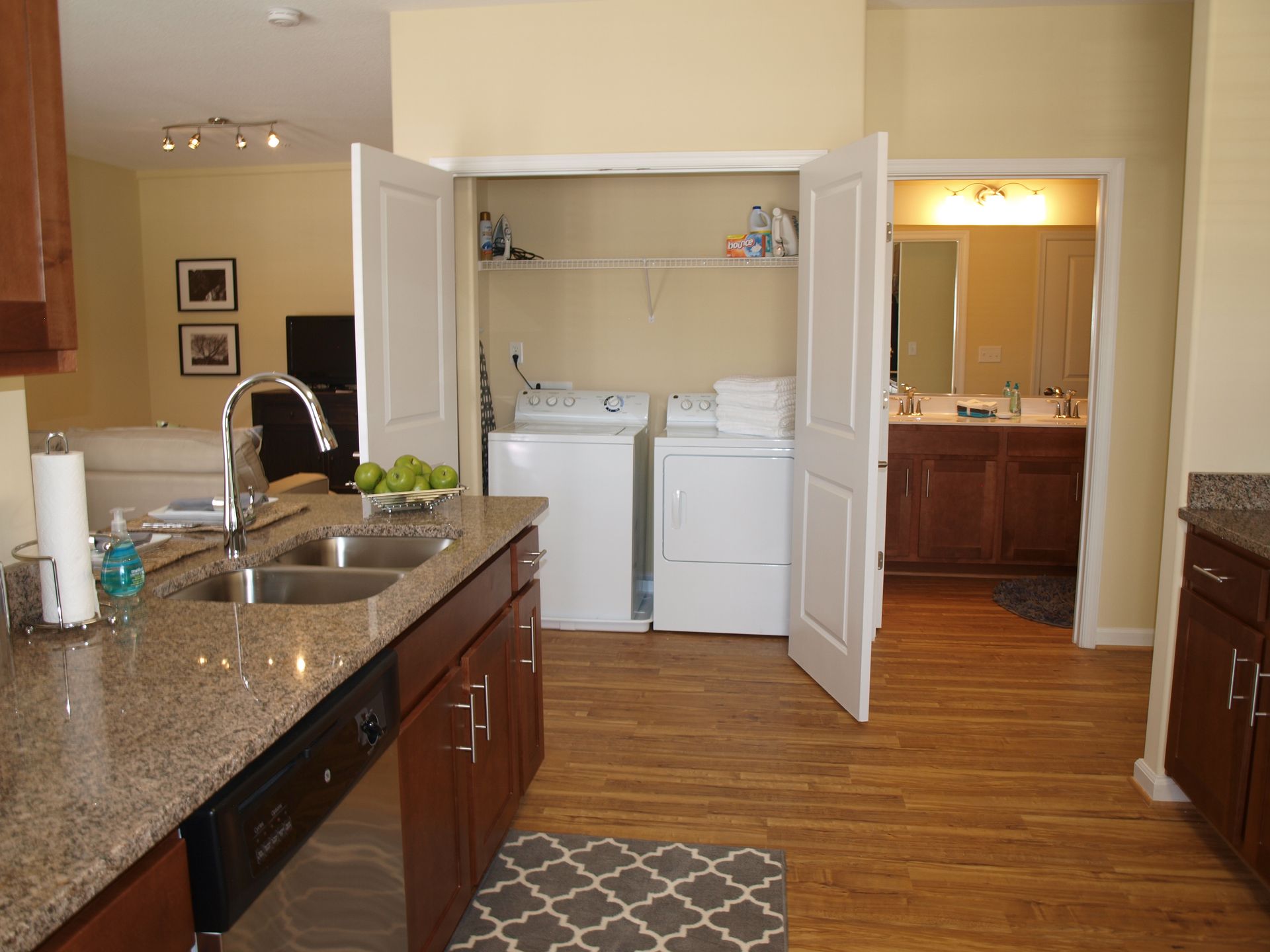 A kitchen with a washer and dryer in a closet