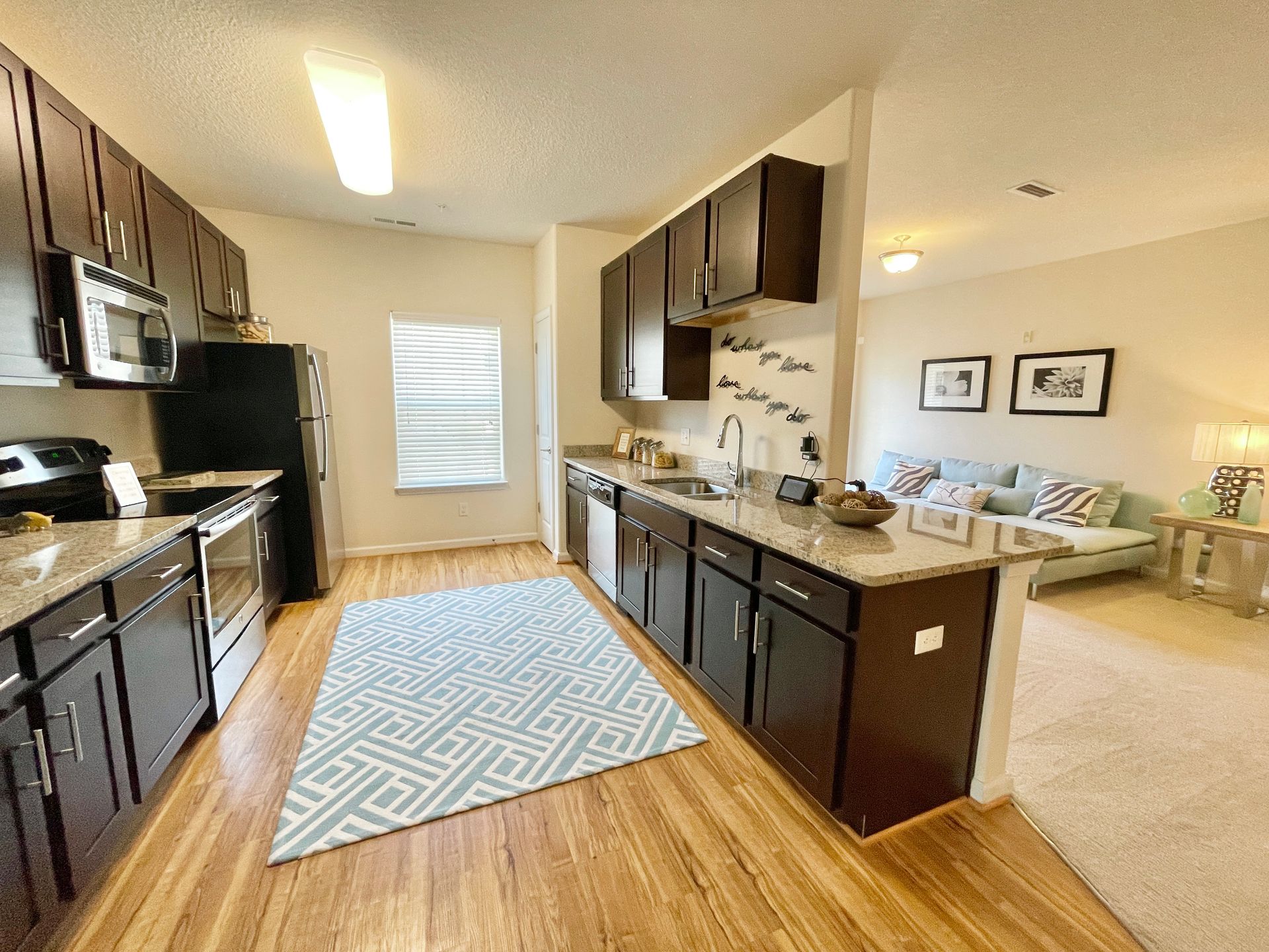 A kitchen with stainless steel appliances and wooden cabinets