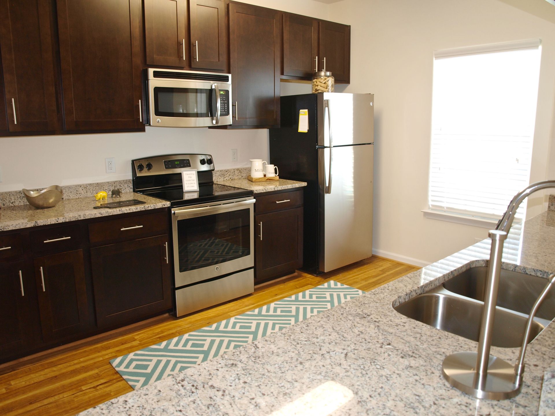 A kitchen with stainless steel appliances and granite counter tops