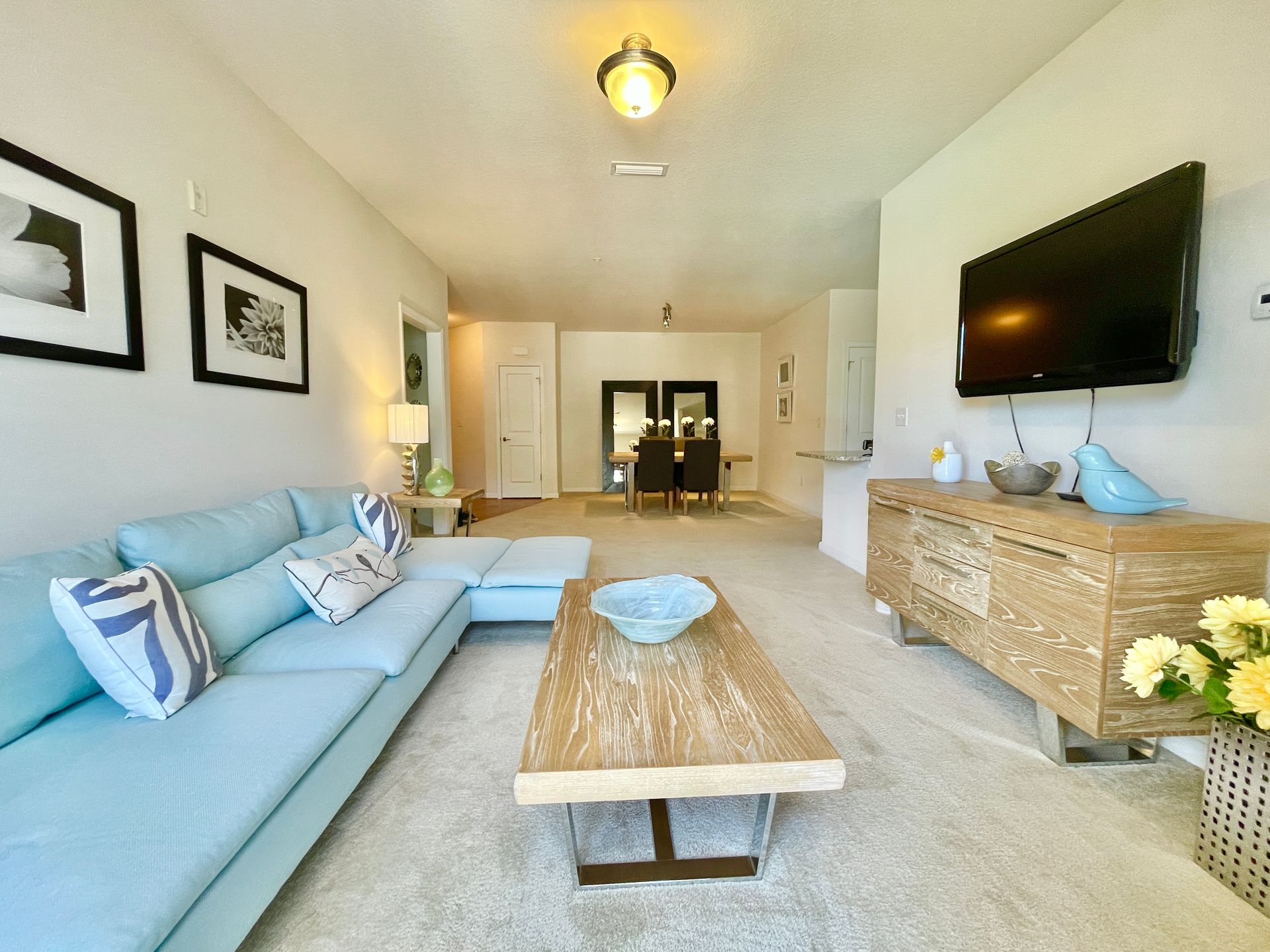 A living room with a couch , coffee table , and television.