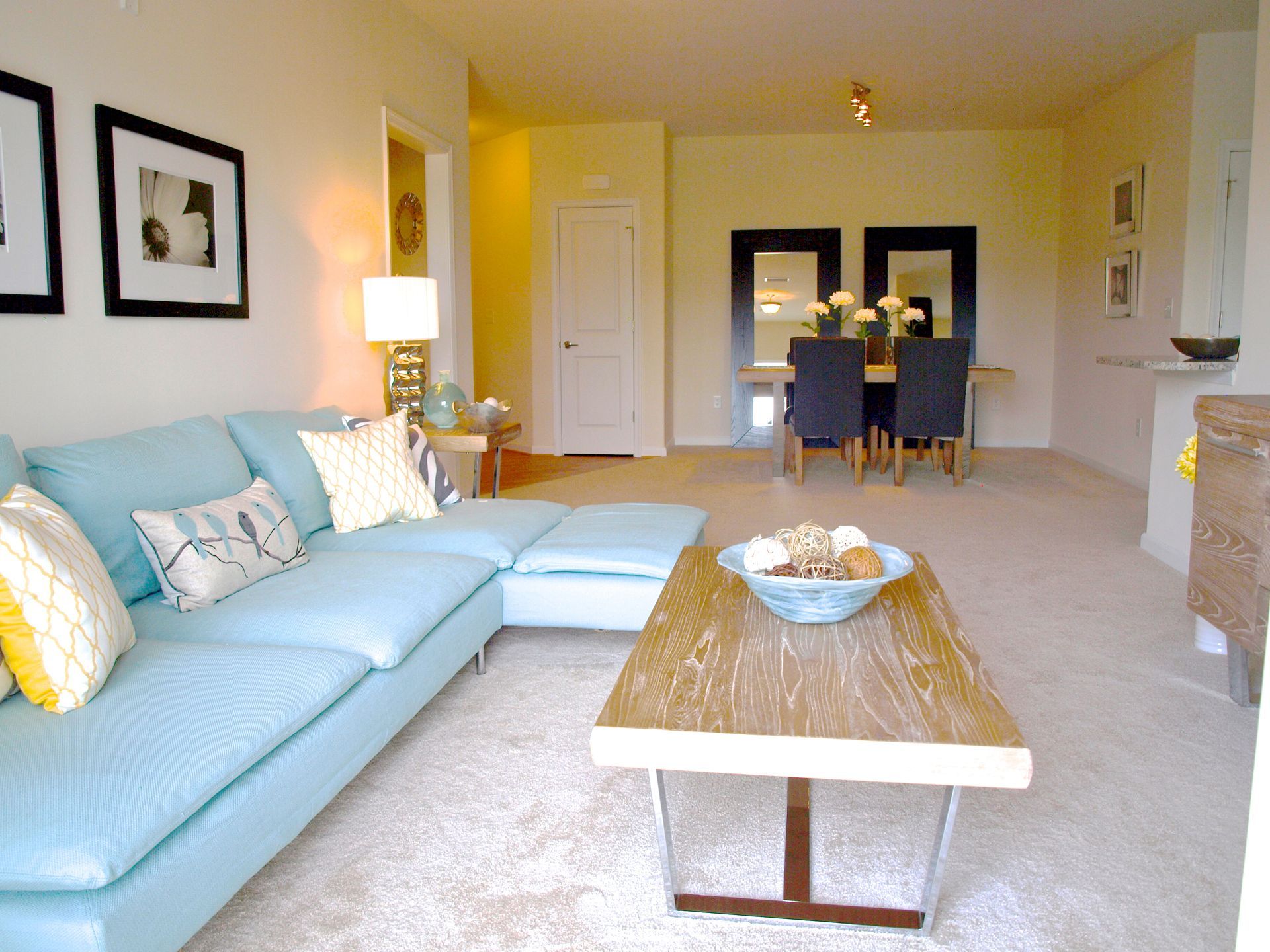 A living room with a blue couch and a coffee table