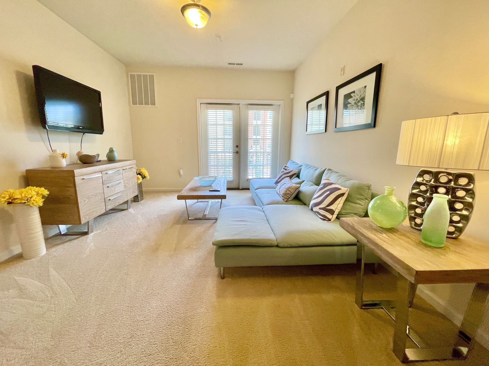 A living room with a couch and a flat screen tv