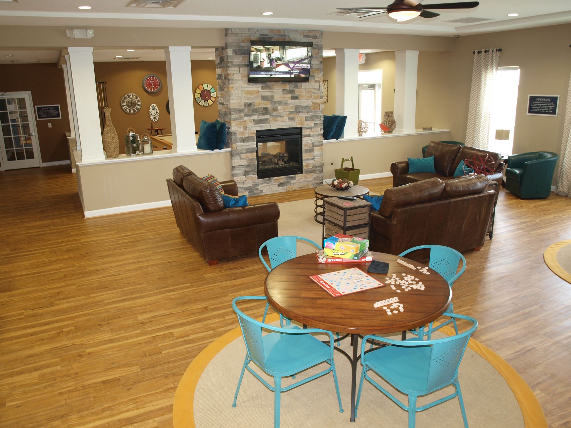 A living room with a table and chairs and a fireplace