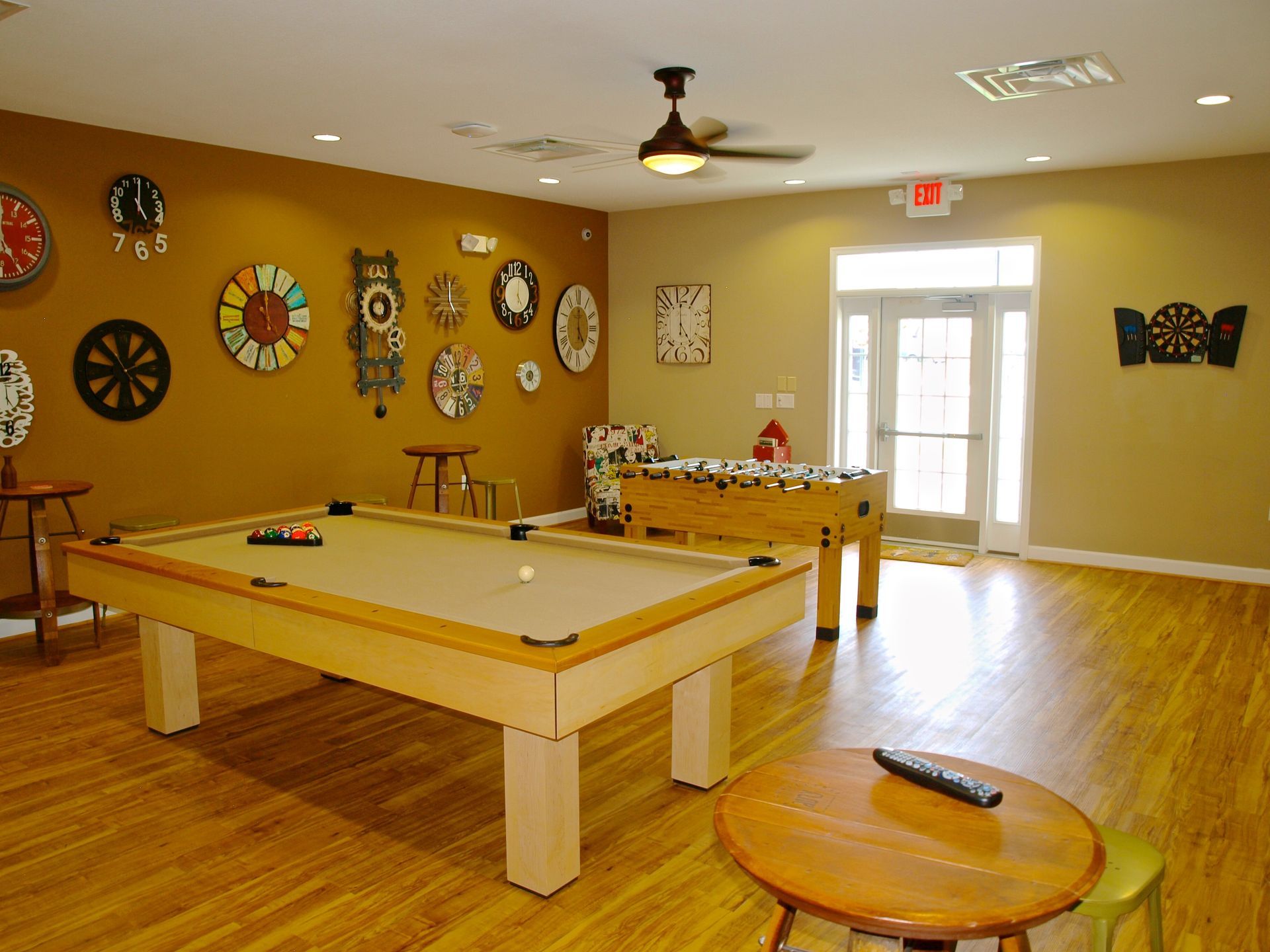 A game room with a pool table and a foosball table