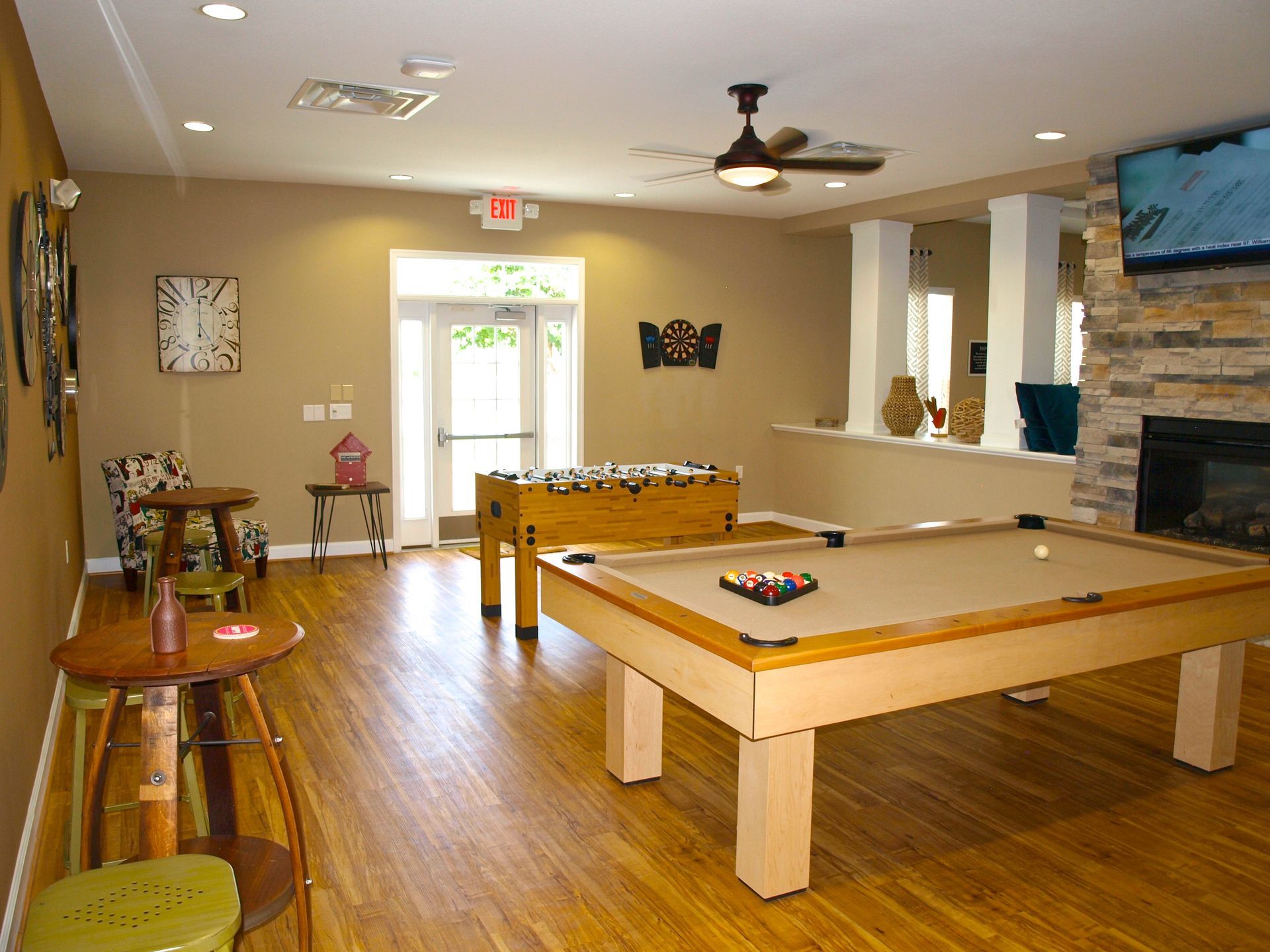 A room with a pool table and a foosball table