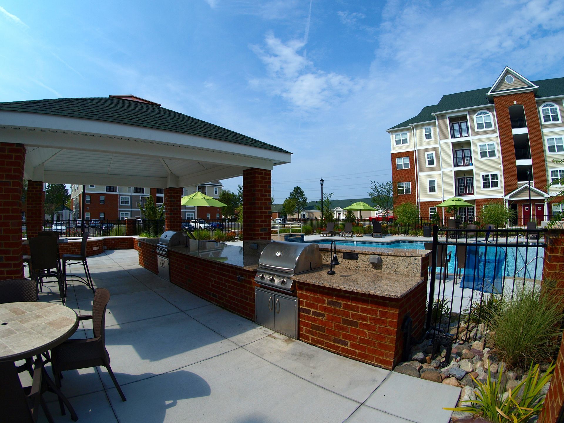 A large building with a swimming pool in front of it