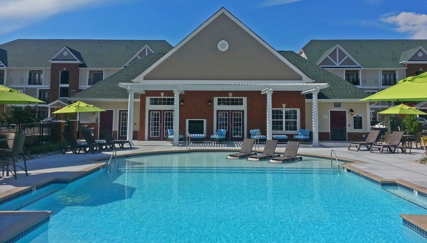 A large swimming pool in front of a large building