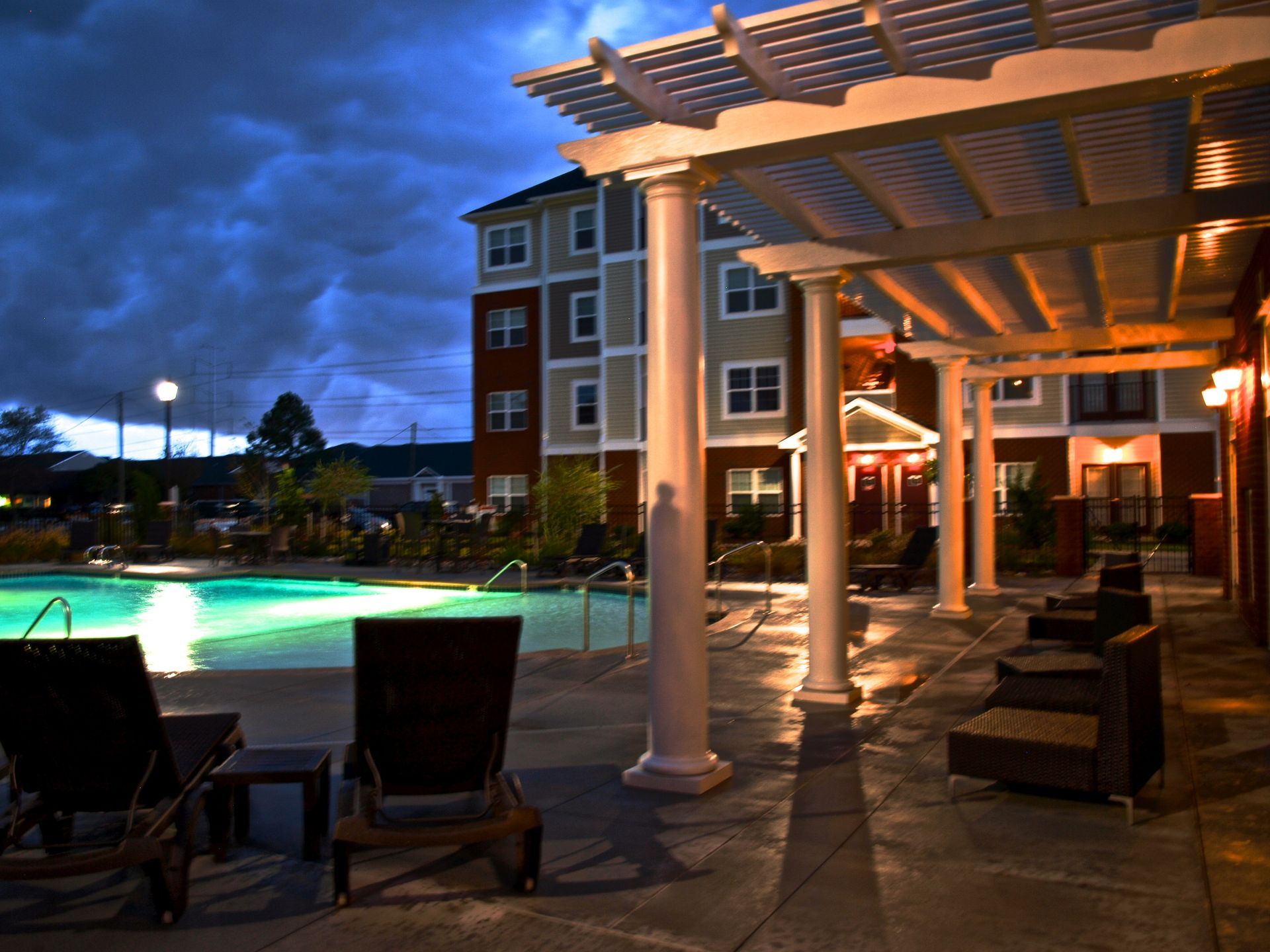 A large swimming pool is lit up at night
