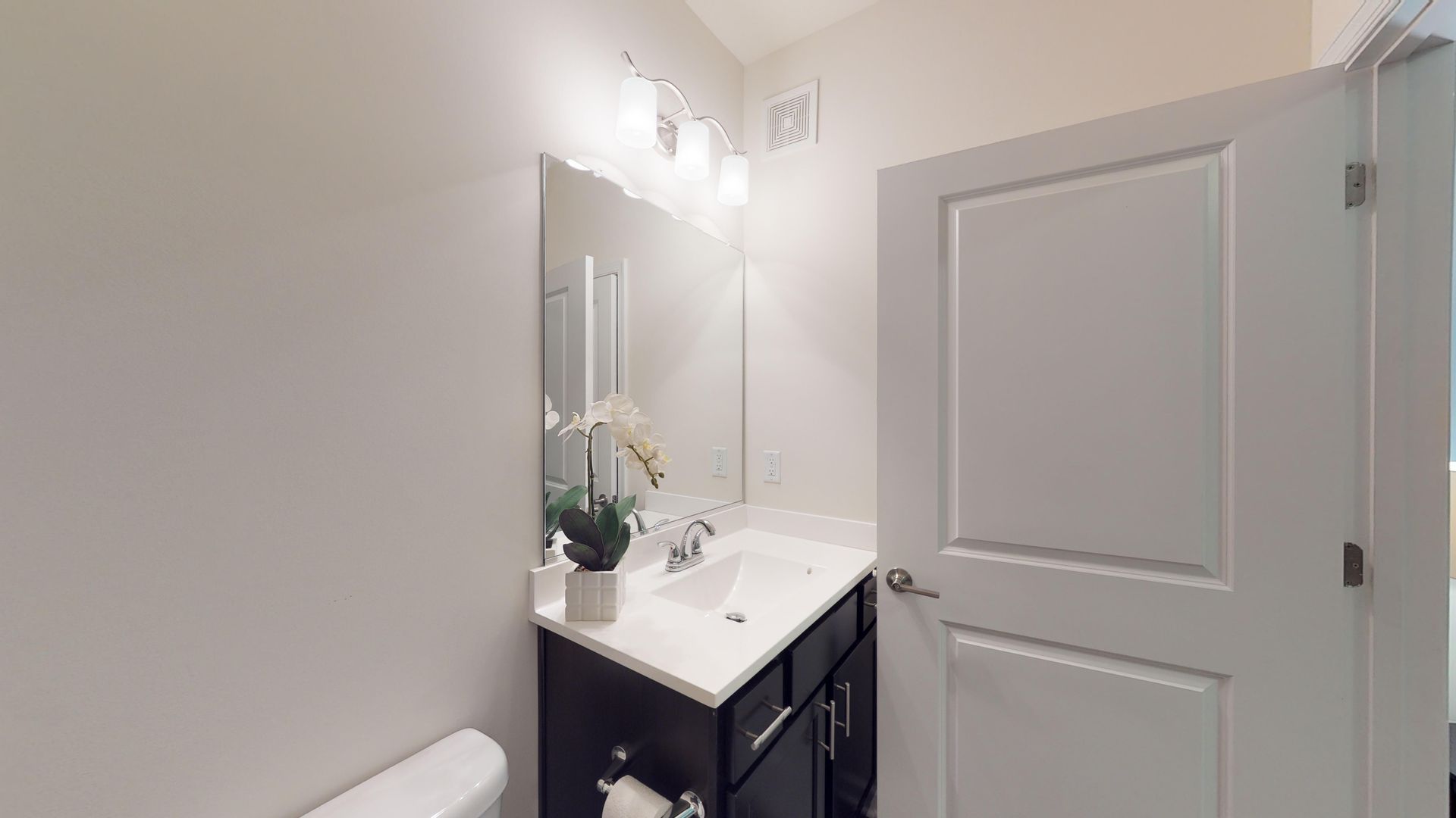 A bathroom with a sink , toilet and mirror.