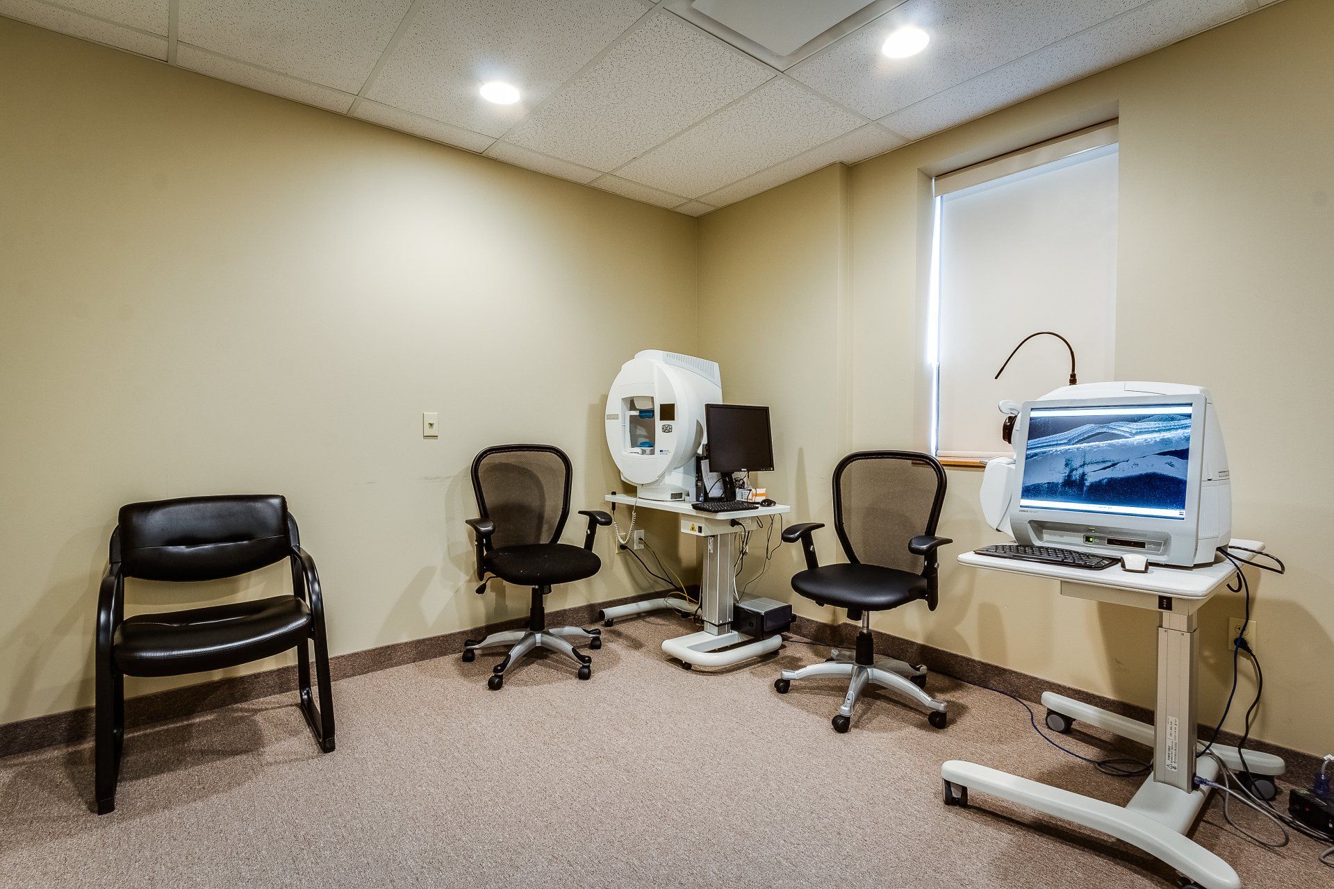 There are two chairs and a computer in the room.