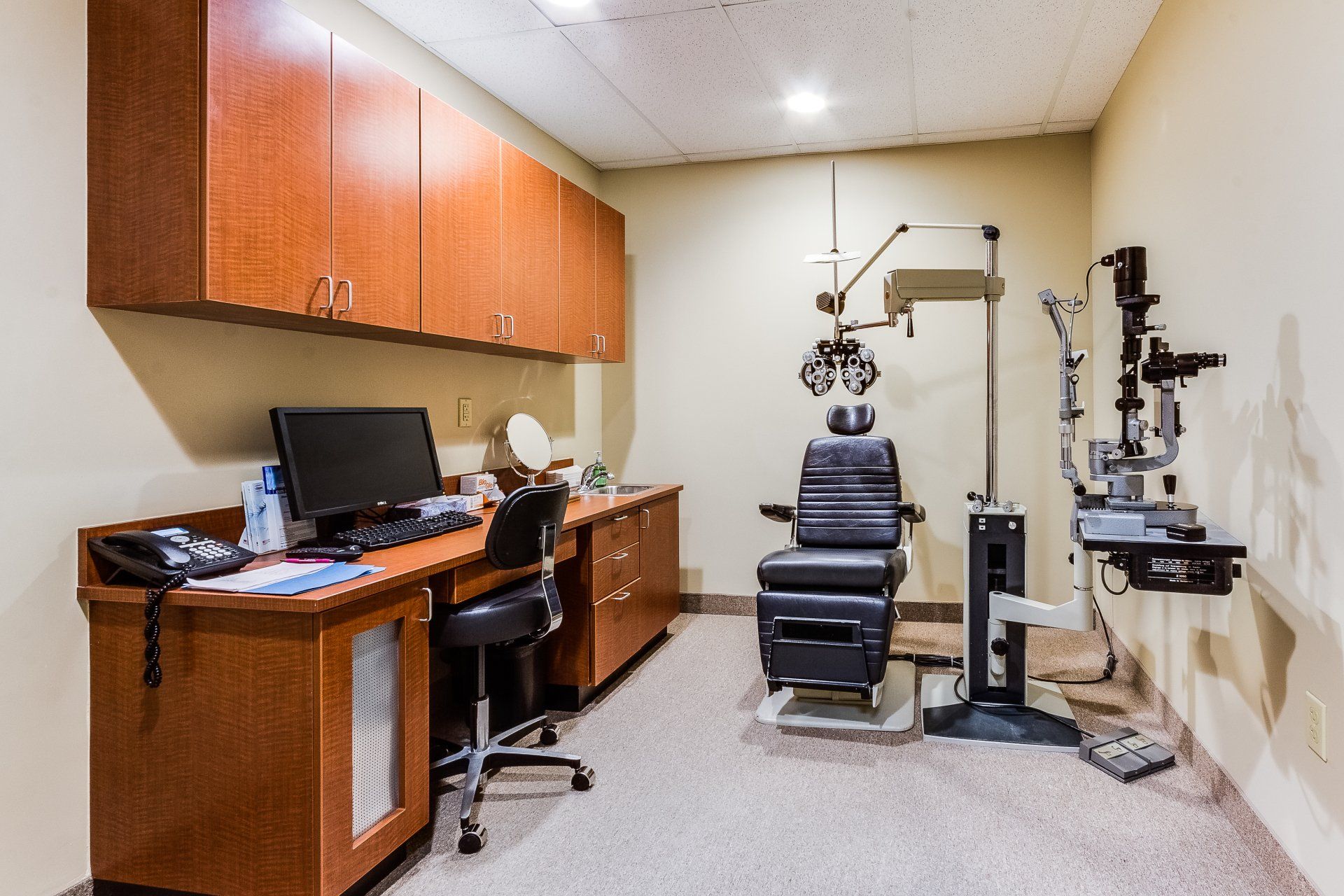 An ophthalmologist 's office with a chair and a computer