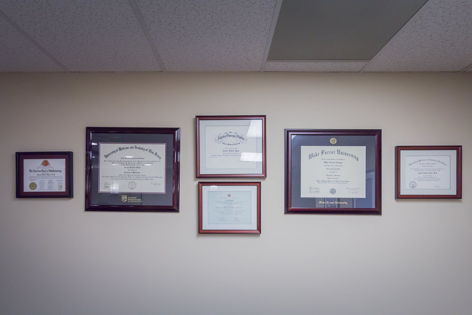 Several framed certificates are hanging on a wall