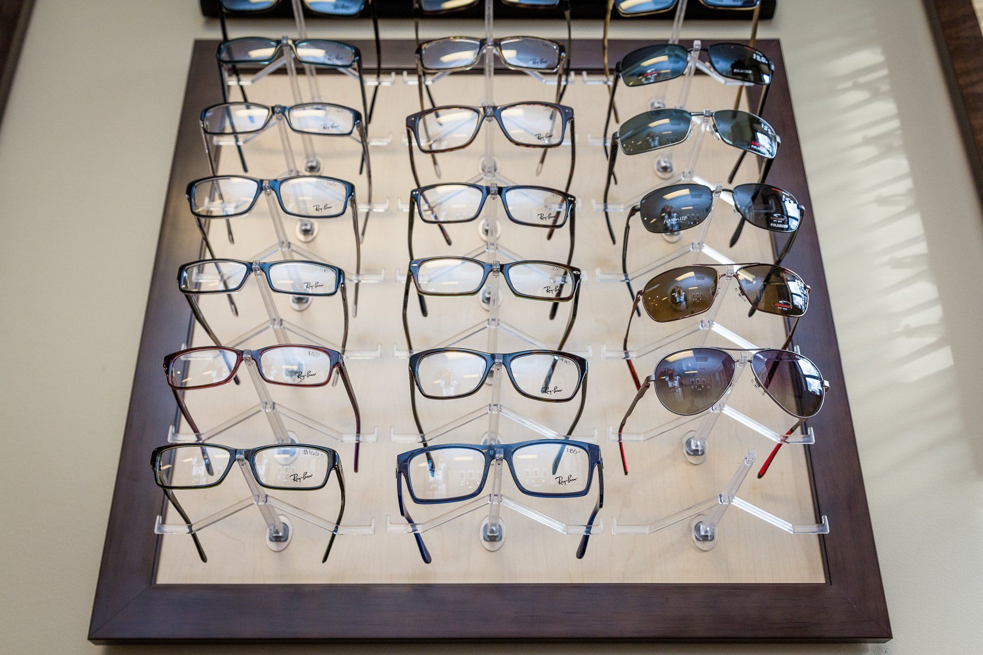 A display of glasses and sunglasses on a table.