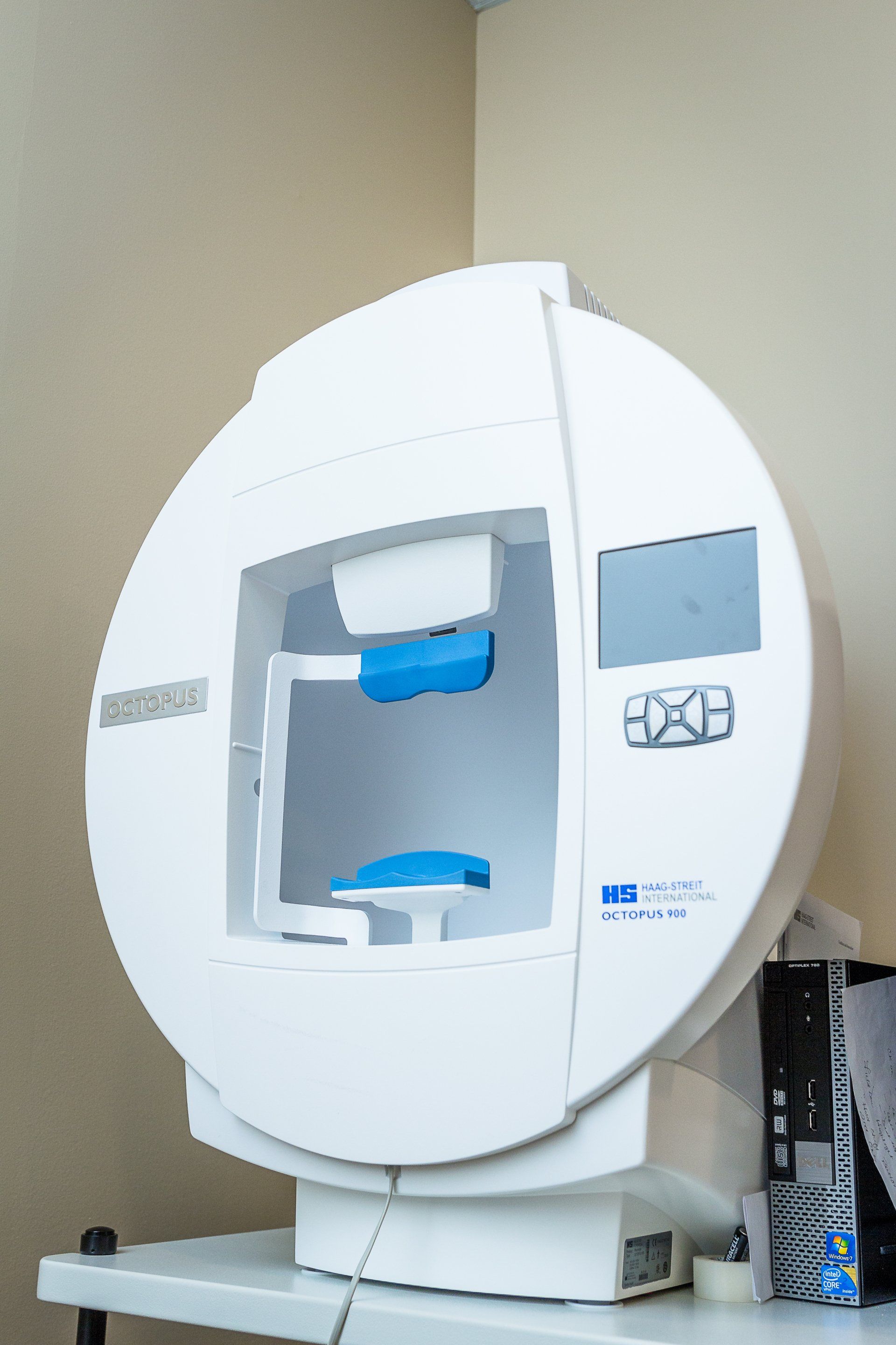 A white machine is sitting on top of a white table.