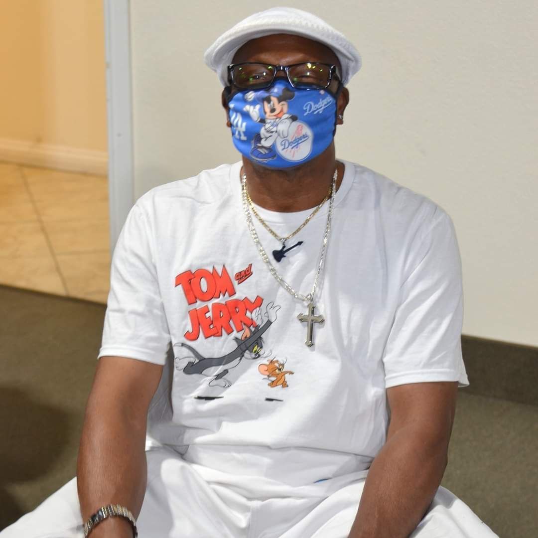 A man wearing a mask and a tom and jerry shirt