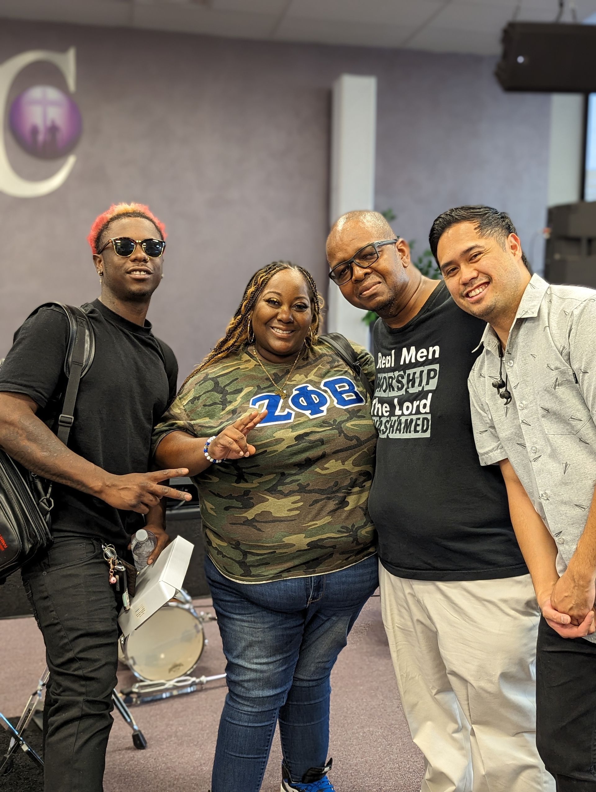 A group of people are posing for a picture in a room.