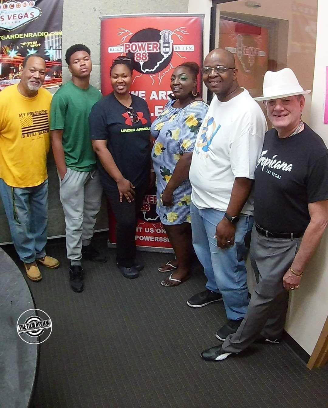 A group of people standing in front of a sign that says power
