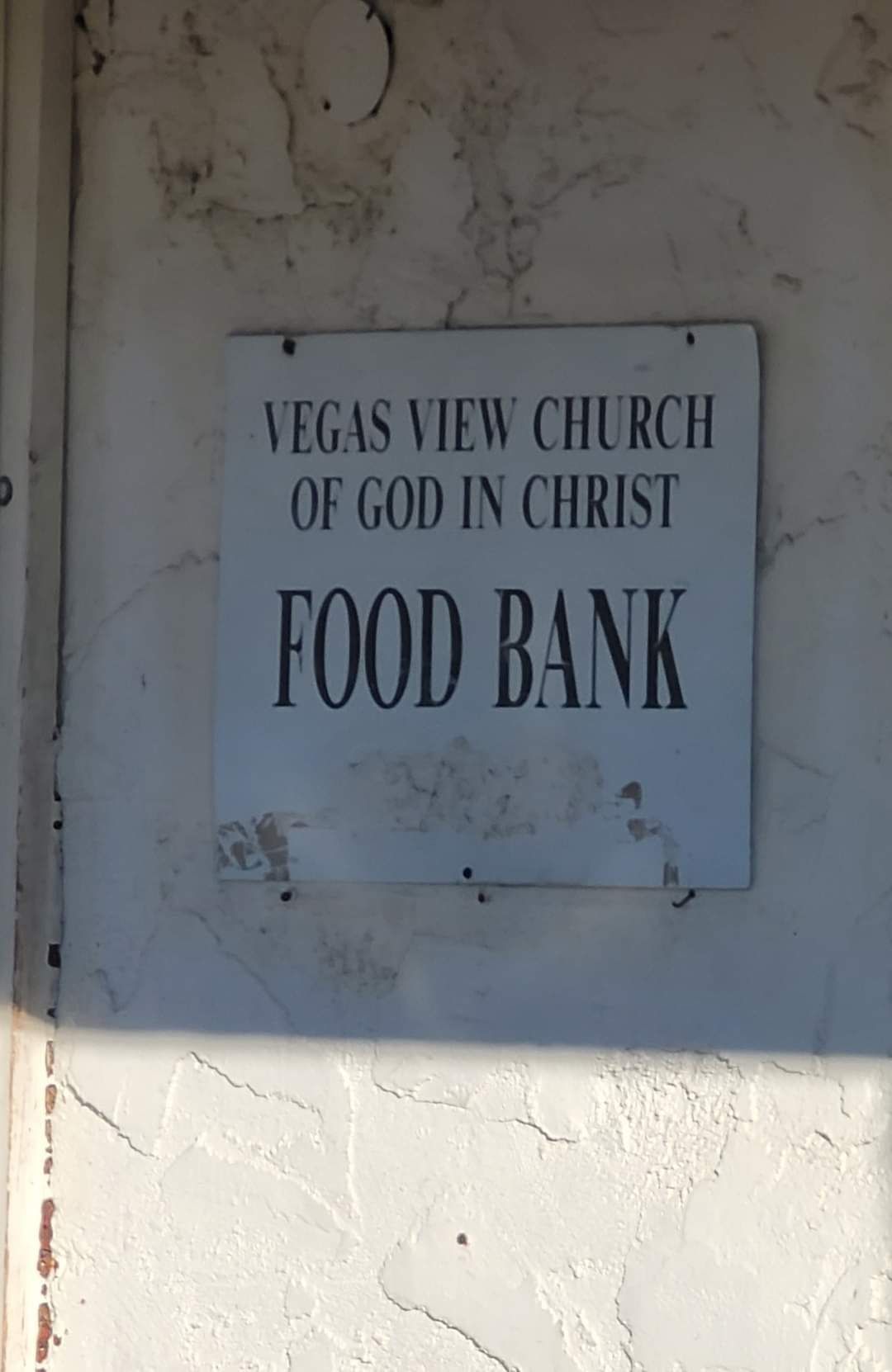 A sign for the vegas view church of god in christ food bank
