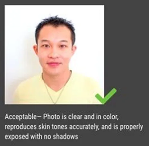 Headshot of a man with accurate skin tone and no shadows, marked as acceptable.